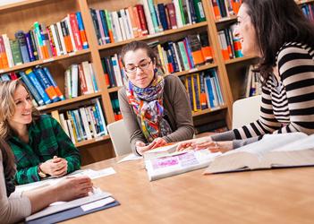 UB counseling students sitting around a table